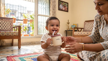 Baby drinking independently from the Cubkins 3-in-1 Sensory Silicone Straw Training Cup