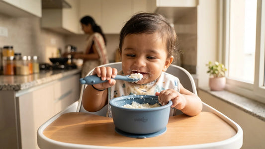 Indian baby eating curd-rice from a Cubkins blue olive silicone suction bowl