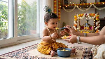 Baby dressed as Krishna offered safe mashed fruit in a Cubkins bowl on Janmashtami