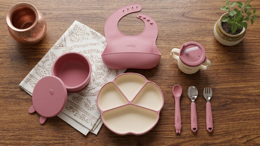 Cubkins Essential Feeding Set of 7 laid out as a baby weaning starter kit