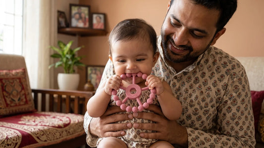 Indian baby safely chewing a Cubkins silicone ring teether held in hands, nothing around the neck