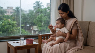 Indian mother giving ORS by Cubkins silicone spoon to her baby during monsoon