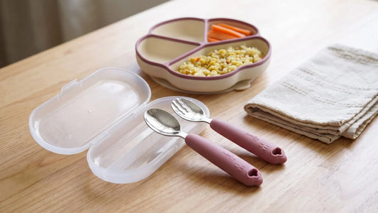 Cubkins Safe-Bite toddler cutlery set — 304 steel spoon and fork with silicone handles beside its travel case