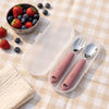 Cubkins raspberry 304 steel toddler spoon and fork in an open frosted travel case on a picnic blanket