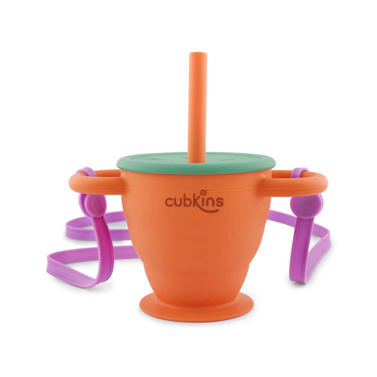 Tangerine Cubkins 2-in-1 silicone sipper and snack cup with green lid, orange straw, and purple carry strap.