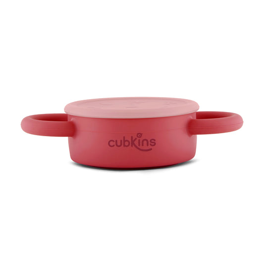 Cubkins cherry red silicone snack cup in its fully collapsed state, highlighting its space-saving and portable design.