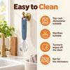 Cubkins blue olive steel toddler fork hanging to dry by its loop, with care icons: top-rack dishwasher, steriliser, turmeric wipes off, not for microwave