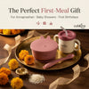 Cubkins raspberry baby feeding set — suction bowl, training cup, and bendable spoon — arranged on a brass puja thali with marigold flowers and rice, styled as the perfect Annaprashan, baby shower, or first birthday gift.