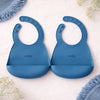 Set of 2 Cubkins silicone baby bibs in Blue Olive color showing adjustable sizing and easy-clean surface