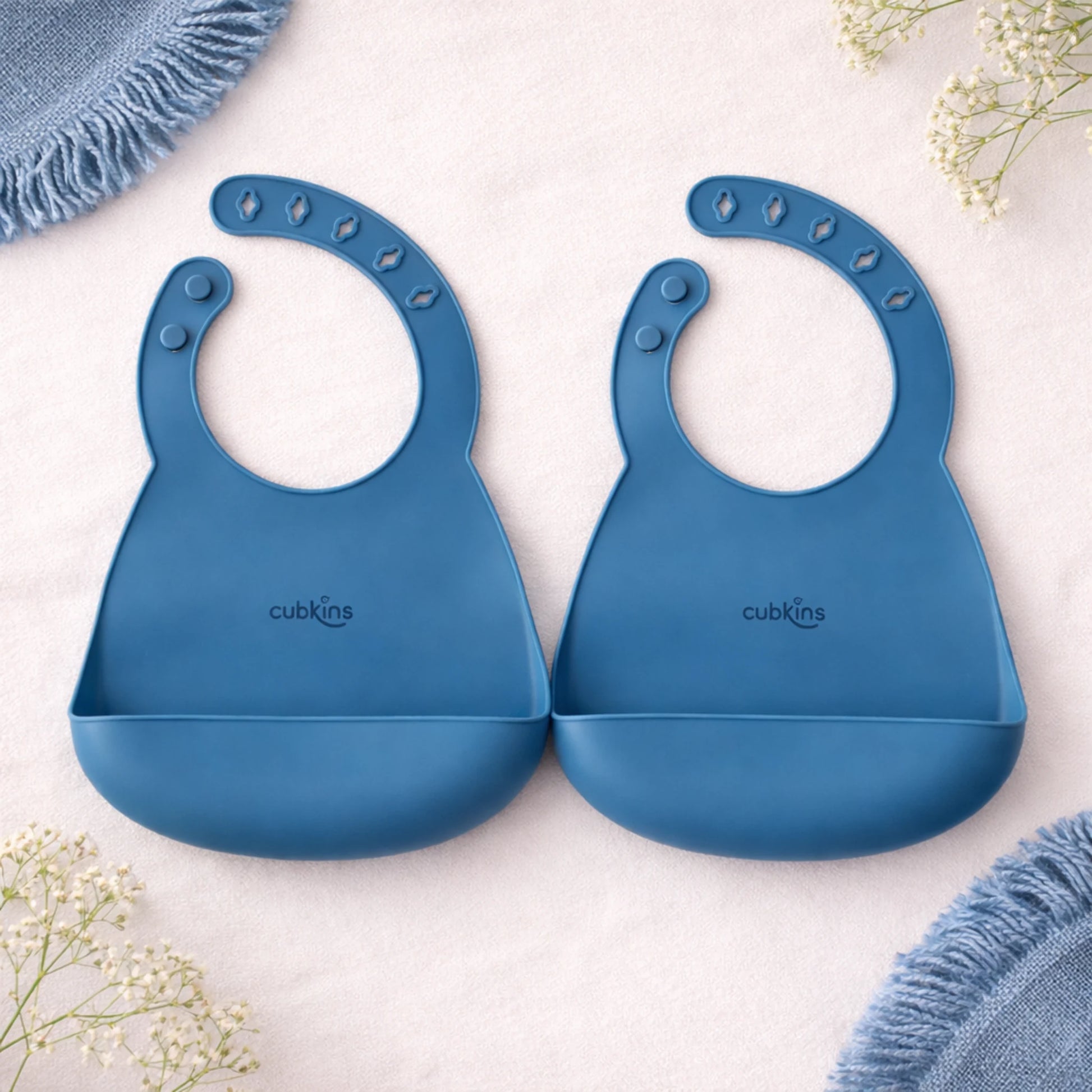 Set of 2 Cubkins silicone baby bibs in Blue Olive color showing adjustable sizing and easy-clean surface