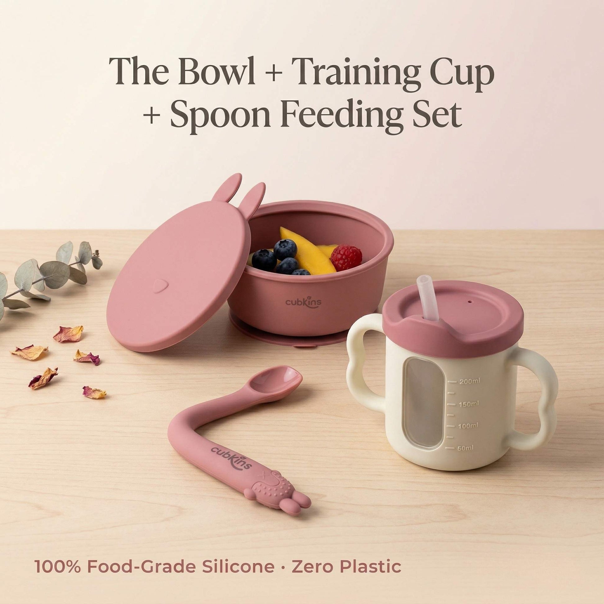 Cubkins 3-piece baby feeding set in Raspberry — silicone suction bowl with bunny-ear lid, 3-in-1 training cup with straw, and bendable spoon. 100% food-grade silicone, zero plastic.