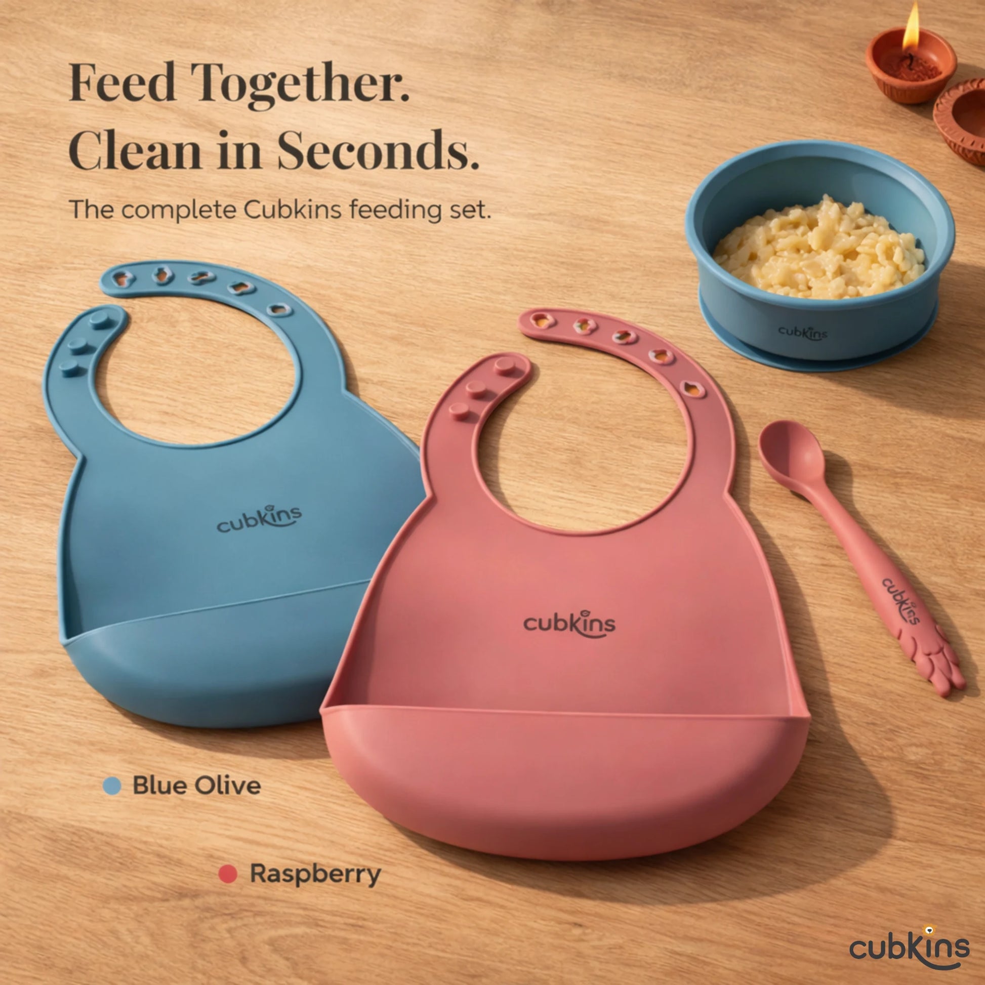 Complete Cubkins feeding set featuring silicone bibs in Blue Olive and Raspberry colors with matching bowl and spoon - feed together, clean in seconds