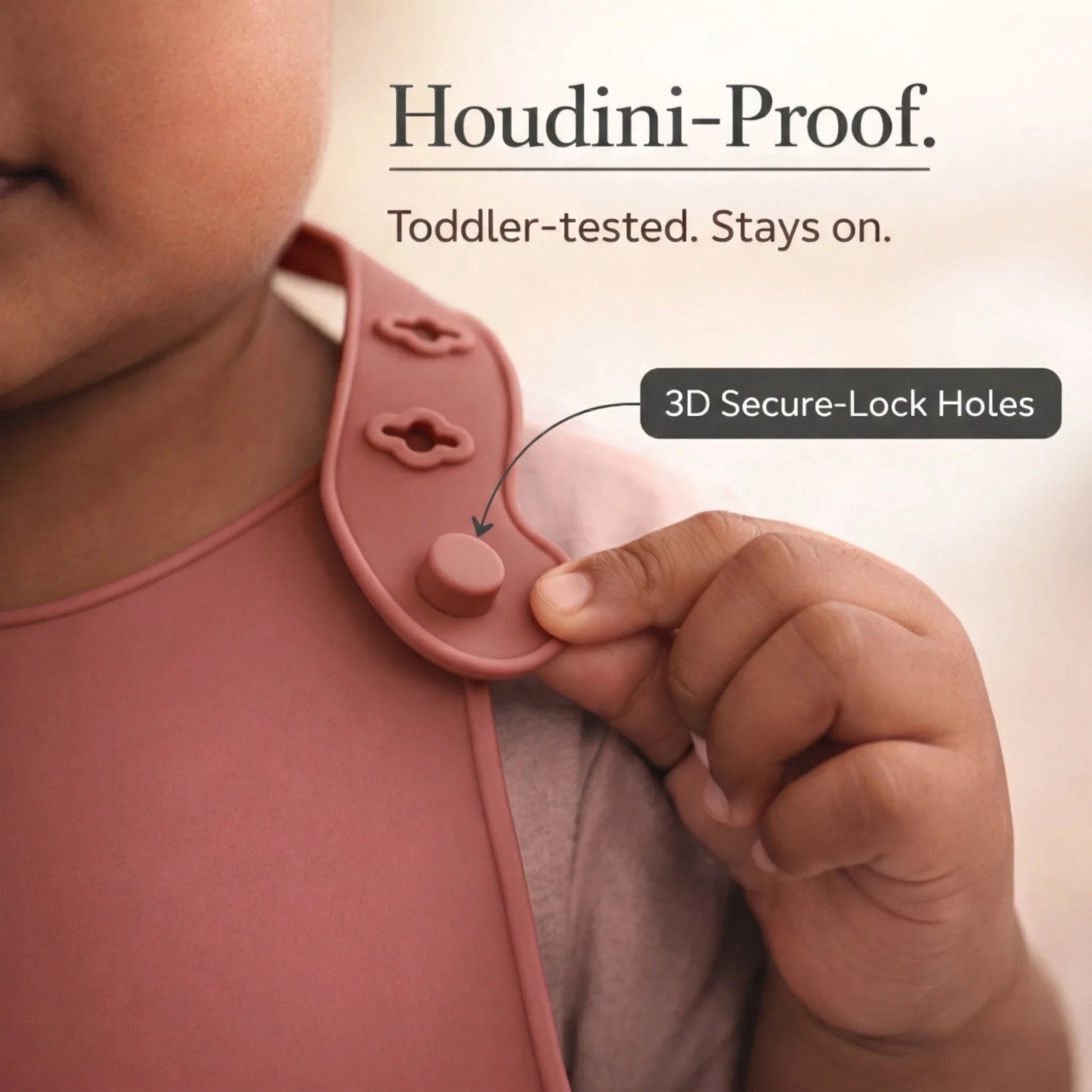 Close-up of Cubkins raspberry bib Houdini-proof 3D secure-lock holes demonstrating adjustable and secure closure mechanism
