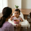 Happy baby self-feeding with Cubkins raspberry ergonomic spoon and suction bowl in high chair