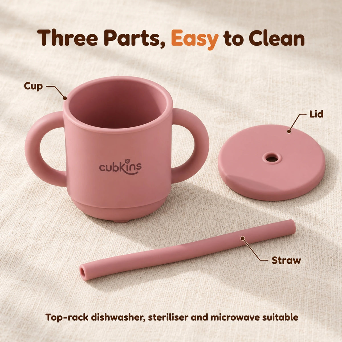 The Cubkins raspberry straw cup taken apart into cup, lid and straw on a cream linen surface
