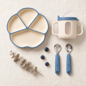 Cubkins plate, cup, spoon and fork set in Blue Olive: silicone suction plate, sensory straw training cup and 304 steel spoon and fork with silicone handles, top-down on linen