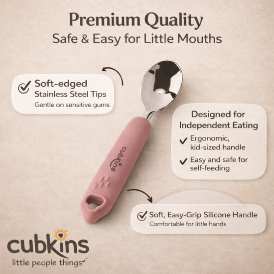 Close-up of Cubkins baby spoon showing rounded stainless steel tip and textured raspberry pink silicone handle