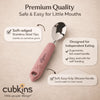 Close-up of Cubkins baby spoon showing rounded stainless steel tip and textured raspberry pink silicone handle