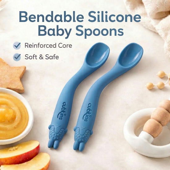 Two blue Cubkins bendable silicone baby spoons with reinforced core and soft animal teether grip, safe for infant gums and first self-feeding