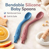 Cubkins bendable silicone baby spoons set of 2 in blue and raspberry with reinforced core and animal-shaped teether handle, shown with fruit and food puree