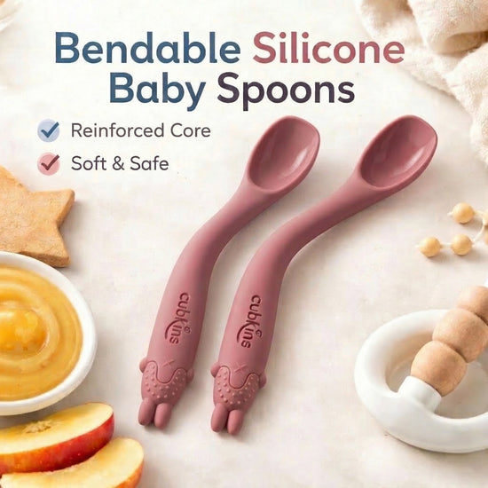 Two raspberry Cubkins bendable silicone baby spoons with reinforced core and soft animal teether grip, BPA-free and safe for infant gums
