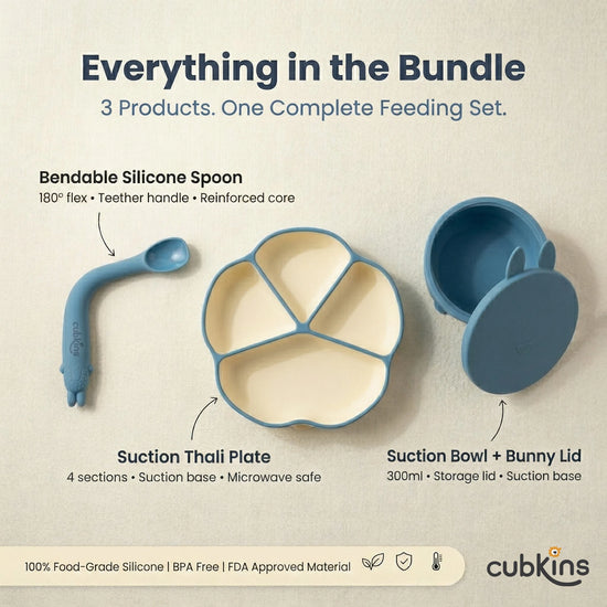 Flat lay of Cubkins Blue Olive 3-piece feeding bundle showing labelled components: bendable silicone spoon with 180° flex, 4-compartment suction thali plate, and suction bowl with bunny-ear storage lid