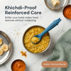 Cubkins blue silicone baby spoon resting in a steel bowl of khichdi, surrounded by Indian baby first foods including banana, dal, and turmeric on a marble surface