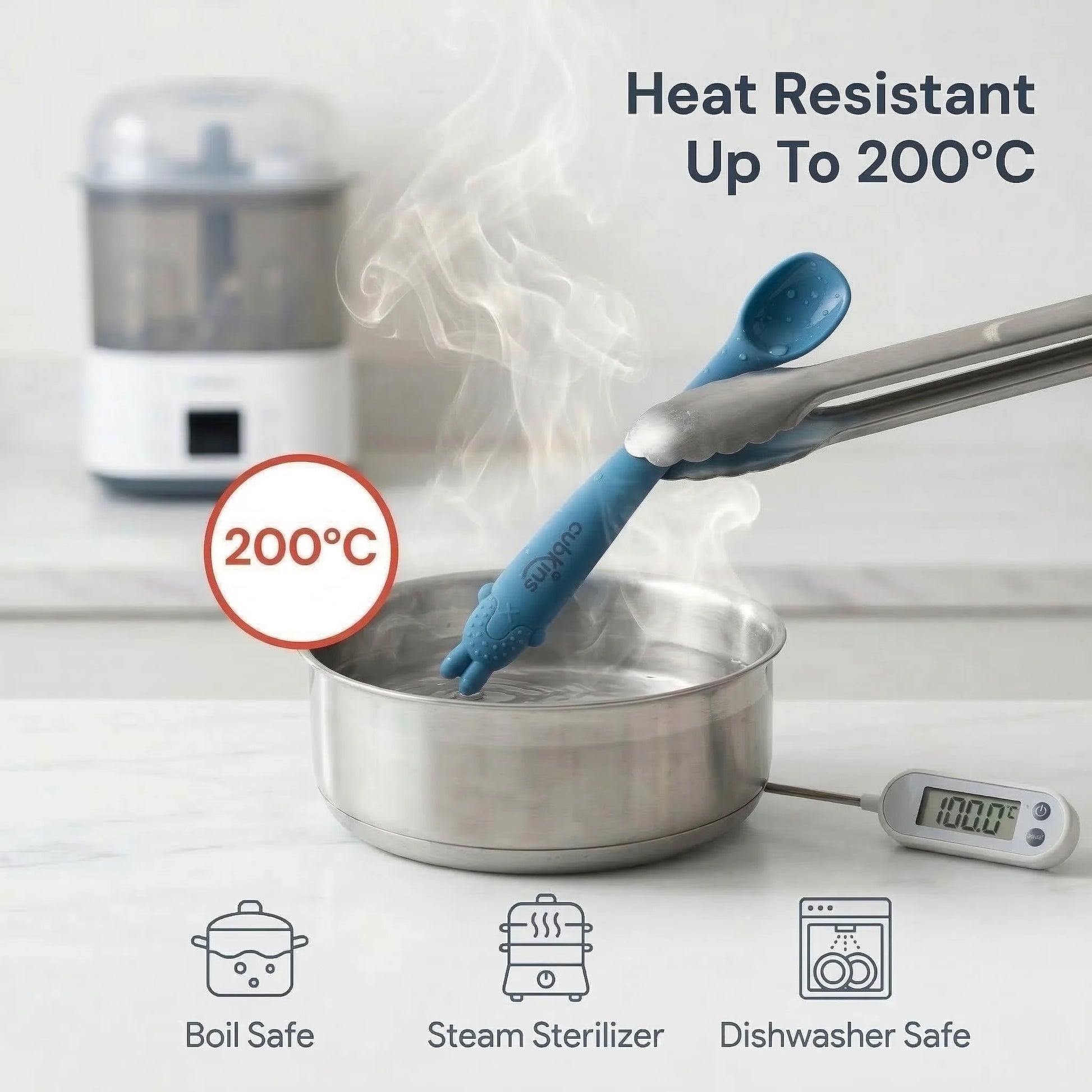 Cubkins blue silicone baby spoon being lifted out of boiling water with tongs, showing 200°C heat resistance; icons below confirm boil safe, steam sterilizer, and dishwasher safe