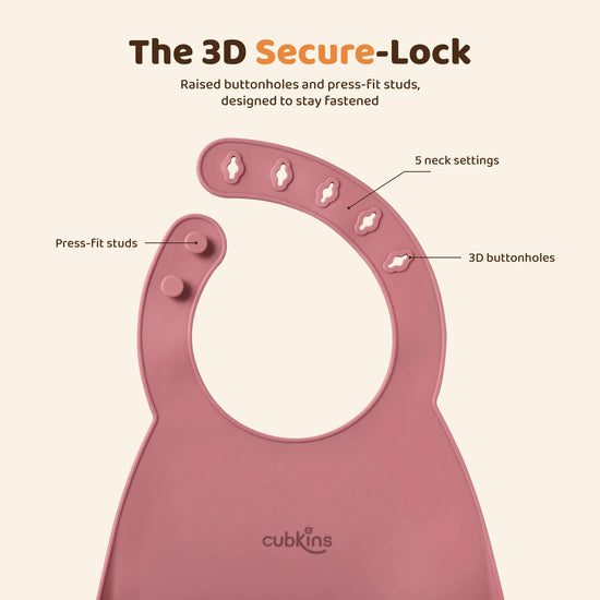 Close-up of the Cubkins raspberry silicone bib neck straps: five raised 3D buttonholes on one strap and two press-fit silicone studs on the other