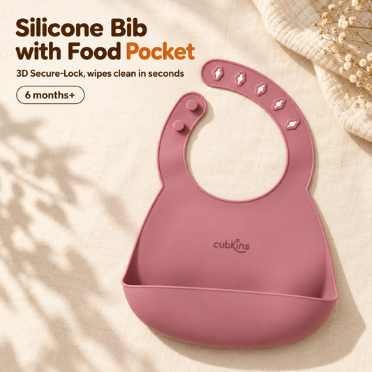 Cubkins raspberry silicone baby bib with five raised 3D buttonholes, two studs and a deep stay-open pocket, on cream linen, for 6 months+