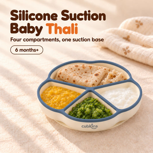 Cubkins silicone suction plate with a blue olive rim, a baby thali of roti, dal, sabzi and curd in its four compartments, for 6 months+