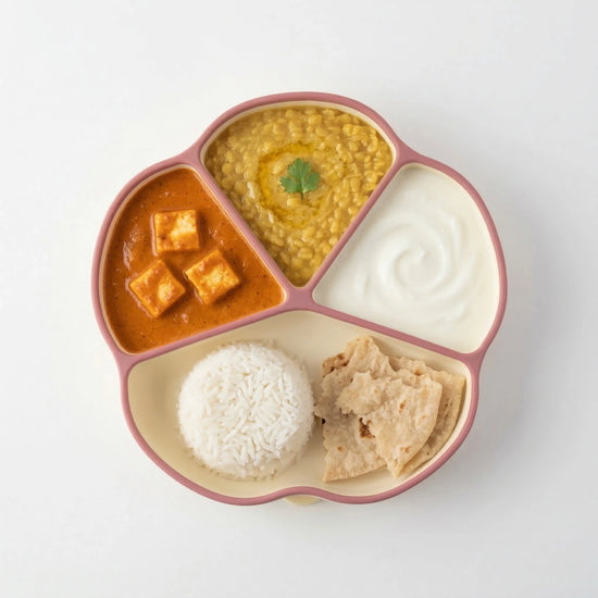 Cubkins raspberry silicone suction plate with 4 sections holding paneer curry, dal, curd, rice and roti for babies