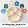 Empty raspberry Cubkins suction plate on marble surface surrounded by safety badges: FDA approved, 100% food-grade silicone, phthalate free, lead and PVC free, BPA free, temperature safe