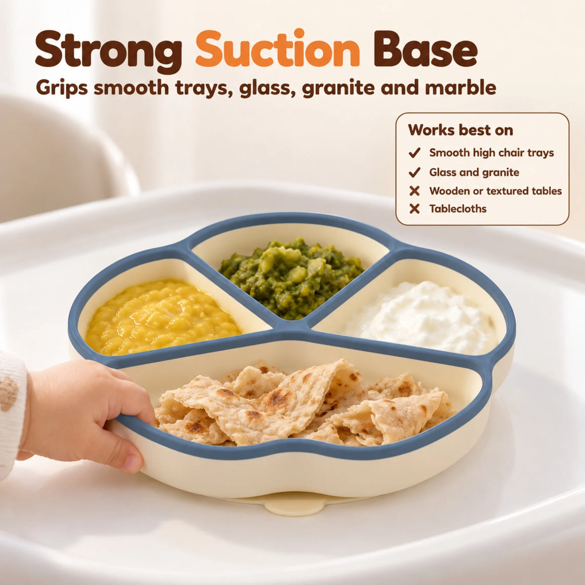Baby hand pulling at the edge of the Cubkins blue olive silicone suction plate while the suction base holds it to the high chair tray