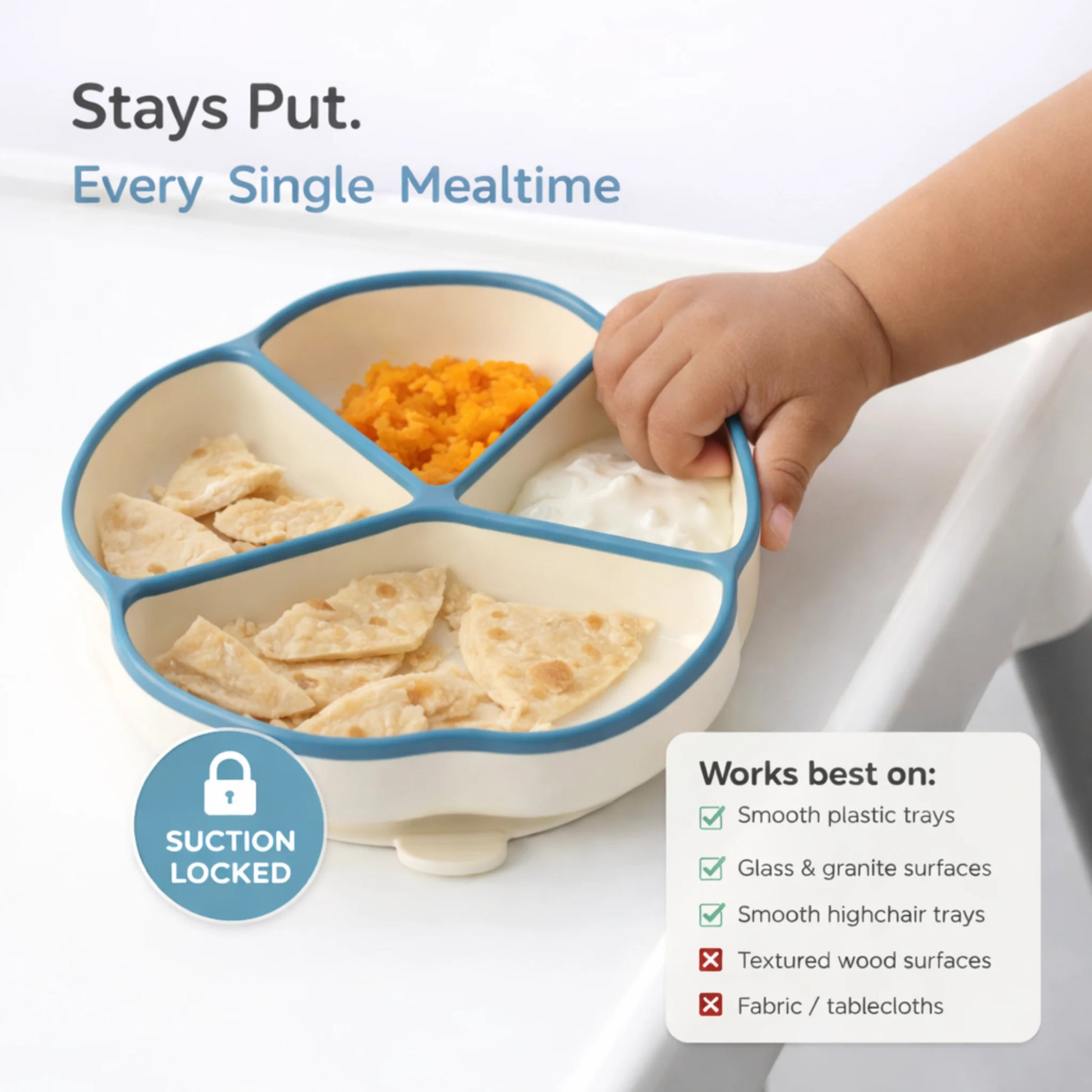 Baby trying to lift blue Cubkins suction plate while it stays locked to highchair tray — works best on smooth plastic trays, glass, and granite