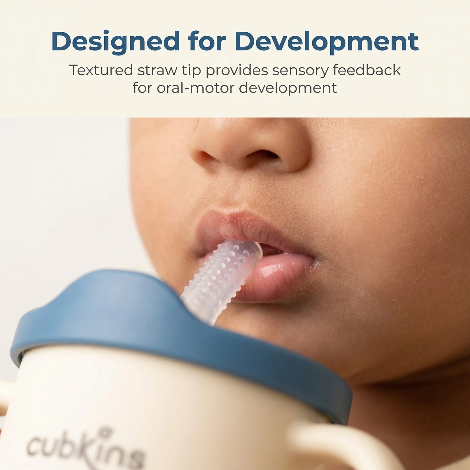 Close-up of a baby using the Cubkins textured silicone sensory straw with blue lid, designed to provide sensory feedback for oral-motor development