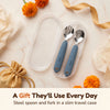 Cubkins blue olive steel toddler spoon and fork in an open travel case, styled as a gift with marigolds, gold ribbon and a silk potli pouch