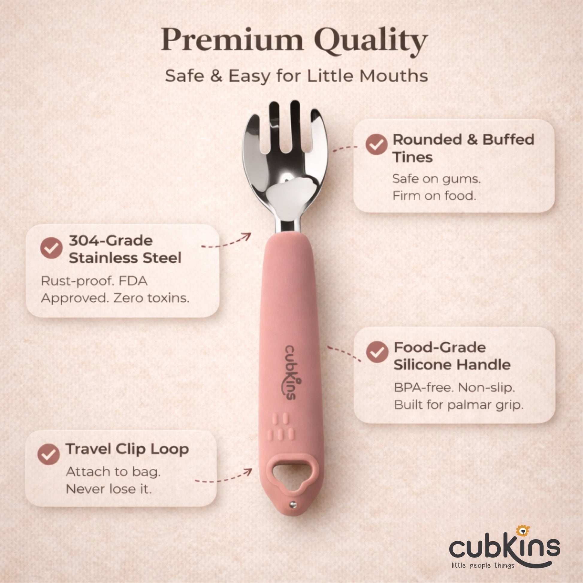 Cubkins Raspberry toddler fork feature callout image on a warm beige background, labelling rounded tines safe for gums, 304-grade stainless steel with zero toxins, food-grade silicone handle for palmar grip, and travel clip loop for on-the-go use