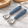 Two Cubkins blue olive silicone-handle stainless steel toddler forks on a marble counter, set of 2 for self-feeding