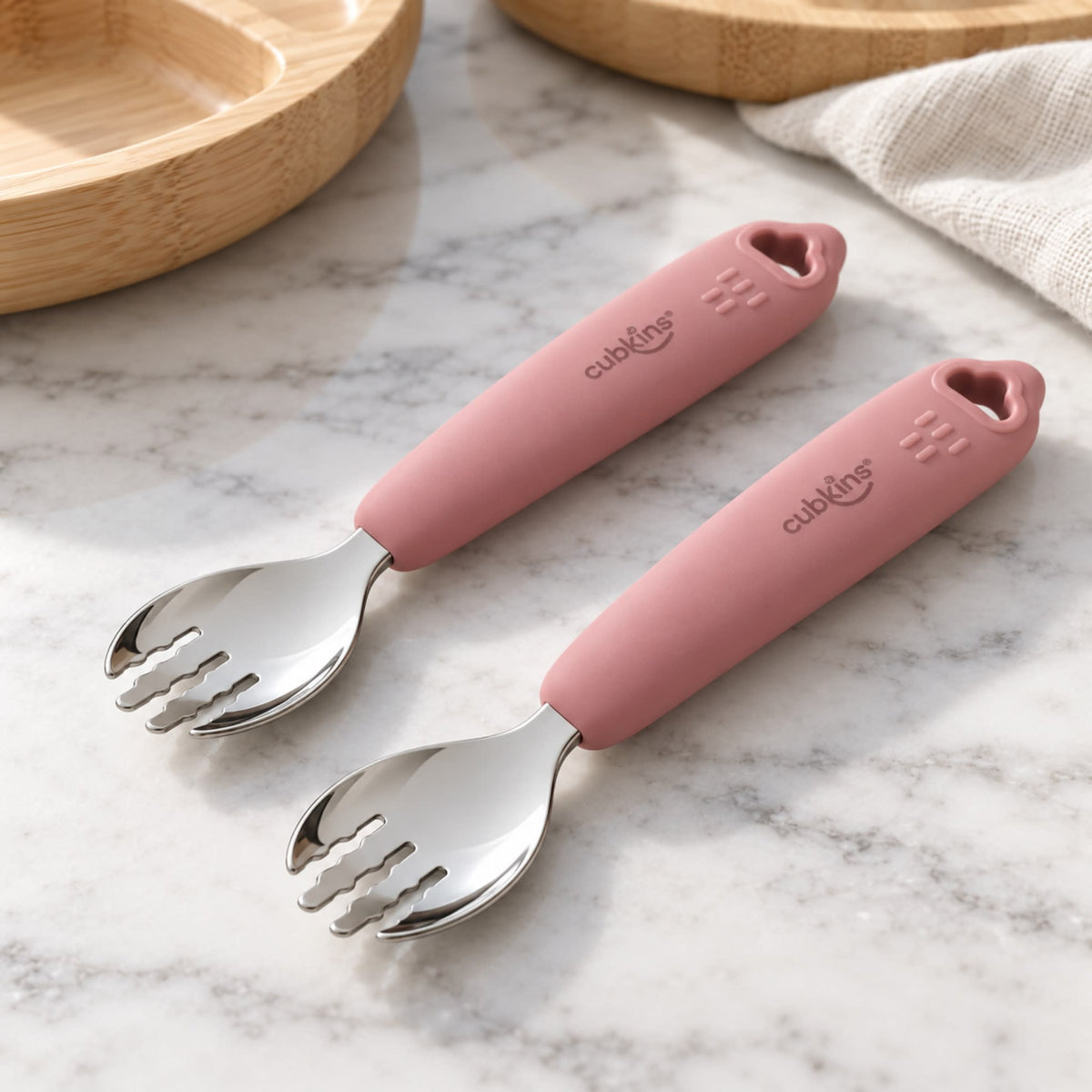 Two Cubkins raspberry silicone-handle stainless steel toddler forks on a marble counter, set of 2 for self-feeding