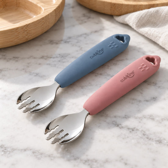 Two Cubkins stainless steel toddler forks, one raspberry and one blue olive silicone handle, on a marble counter, set of 2