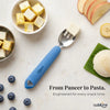 Cubkins Blue Olive toddler fork with a cube of paneer on the tines, surrounded by bowls of paneer, idli on a banana leaf, apple slices, banana, and blueberries, with the text "From Paneer to Pasta. Engineered for every snack time."