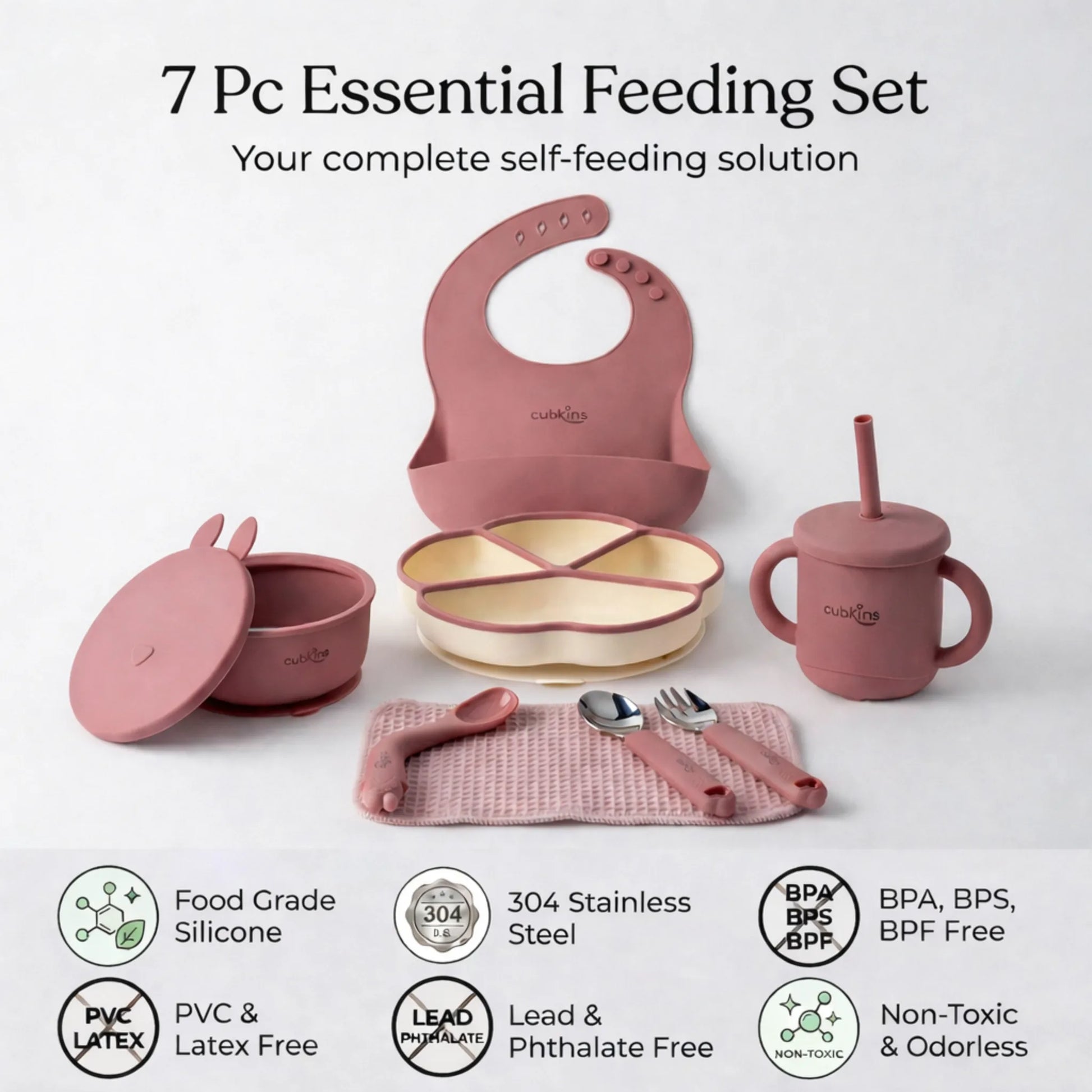 Flatlay of the complete Cubkins raspberry 7-piece Essential Feeding Set — silicone bib, divided suction plate, suction bowl with bunny lid, straw sippy cup, waffle muslin cloth, and stainless steel spoon and fork — with safety certification icons: Food Grade Silicone, 304 Stainless Steel, BPA/BPS/BPF Free, PVC & Latex Free, Lead & Phthalate Free, Non-Toxic & Odorless.