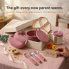 Cubkins 7-piece raspberry pink silicone baby feeding set presented as a gift in a premium cream box with a "For baby" tag, featuring suction plate, suction bowl with lid, bib, straw cup, spoon, fork and teether spoon — styled with marigolds and diya for Annaprashan, baby showers, first birthdays, and Diwali gifting