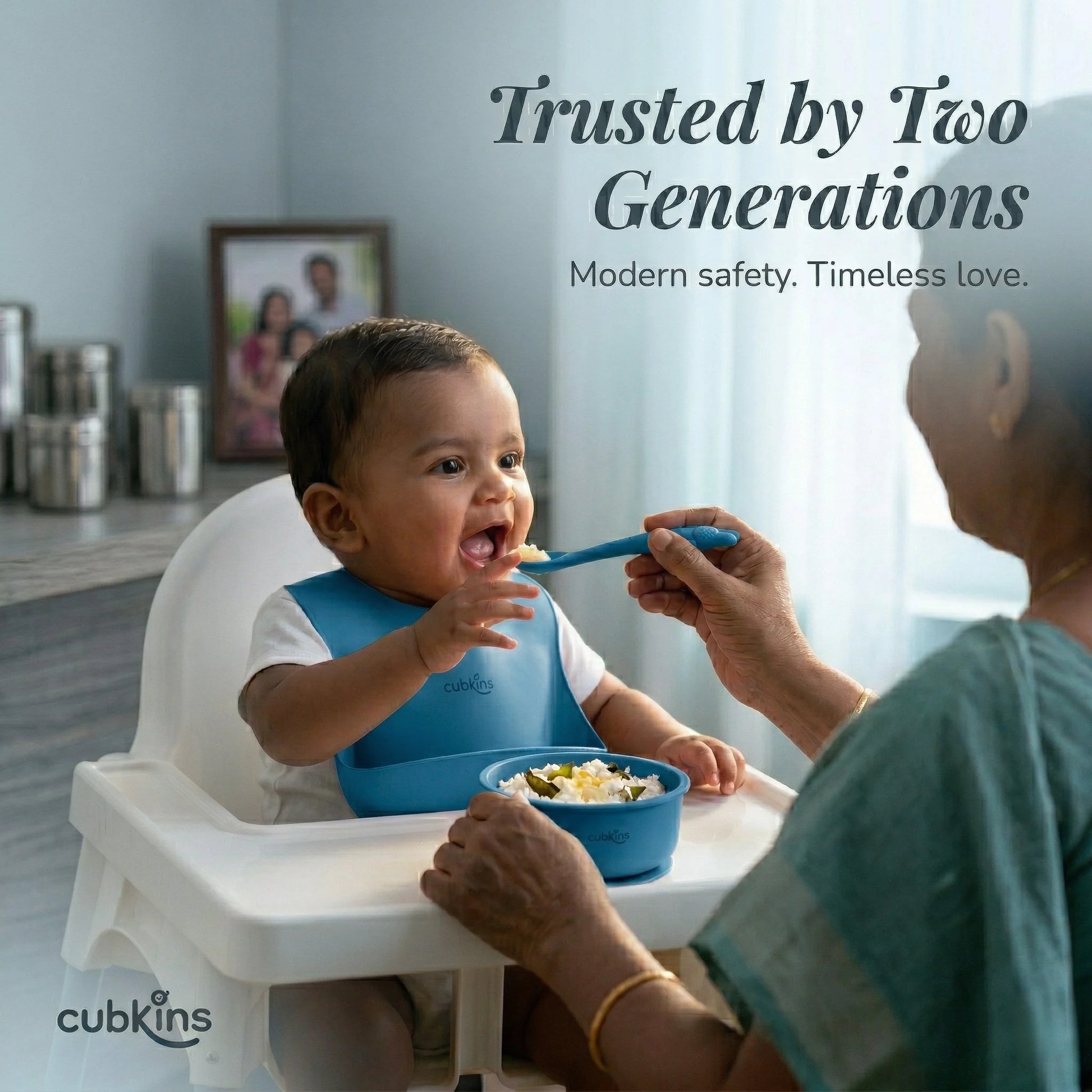 Indian grandmother feeding baby curd rice using Cubkins blue silicone spoon and suction bowl — trusted by two generations