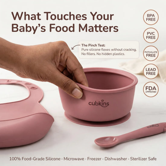 Pinch test demonstrating Cubkins raspberry silicone bowl is BPA free, PVC free, phthalate free and FDA approved — 100% food-grade silicone