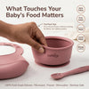 Pinch test demonstrating Cubkins raspberry silicone bowl is BPA free, PVC free, phthalate free and FDA approved — 100% food-grade silicone