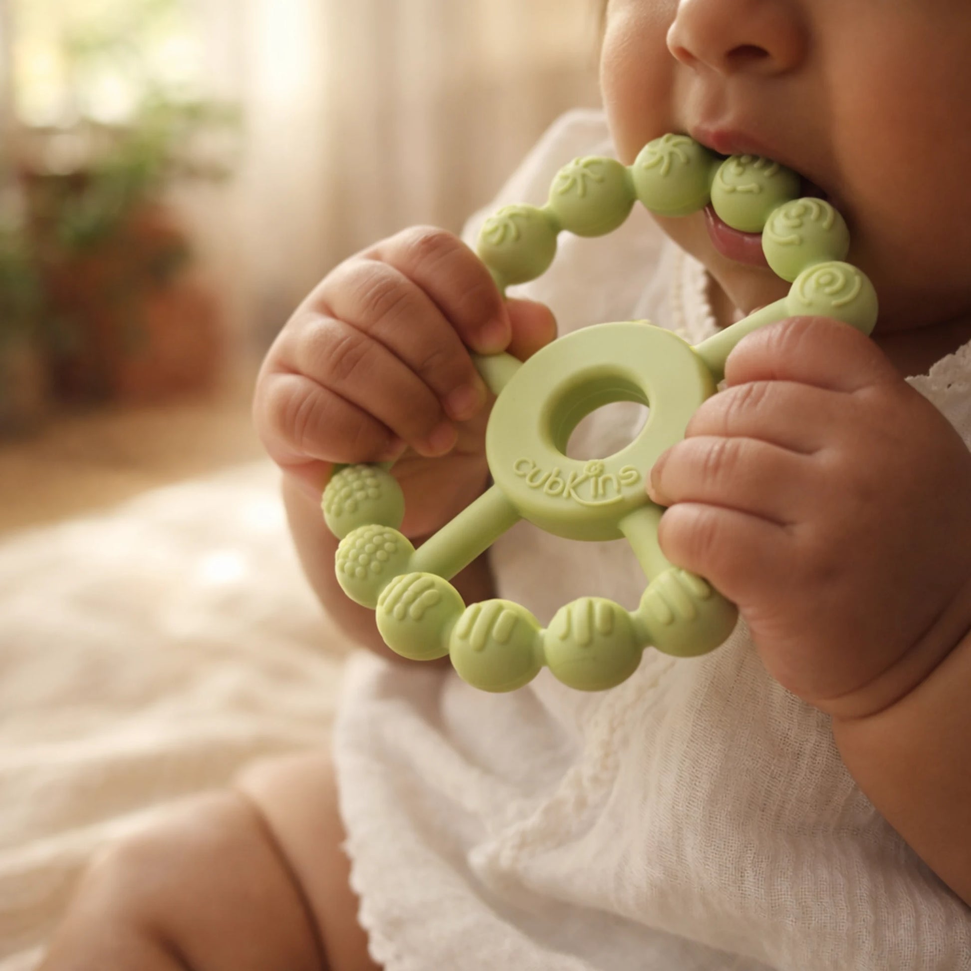Baby gripping and chewing Cubkins Silicone Ring Teether in Lime green – easy to hold for small hands, food-grade silicone, safe for 3 months and above