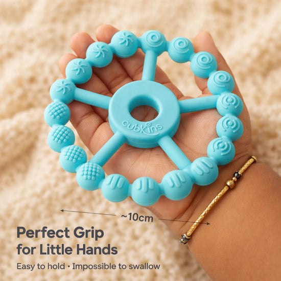 Cubkins Ring Teether in Java Banana held in an adult palm showing 10cm diameter – perfect grip size for babies, easy to hold and impossible to swallow