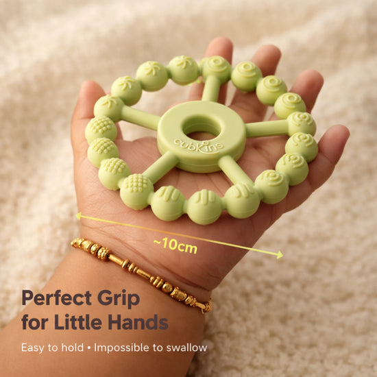Cubkins Ring Teether in Lime held in an adult palm showing 10cm diameter – perfect grip size for babies, easy to hold and impossible to swallow